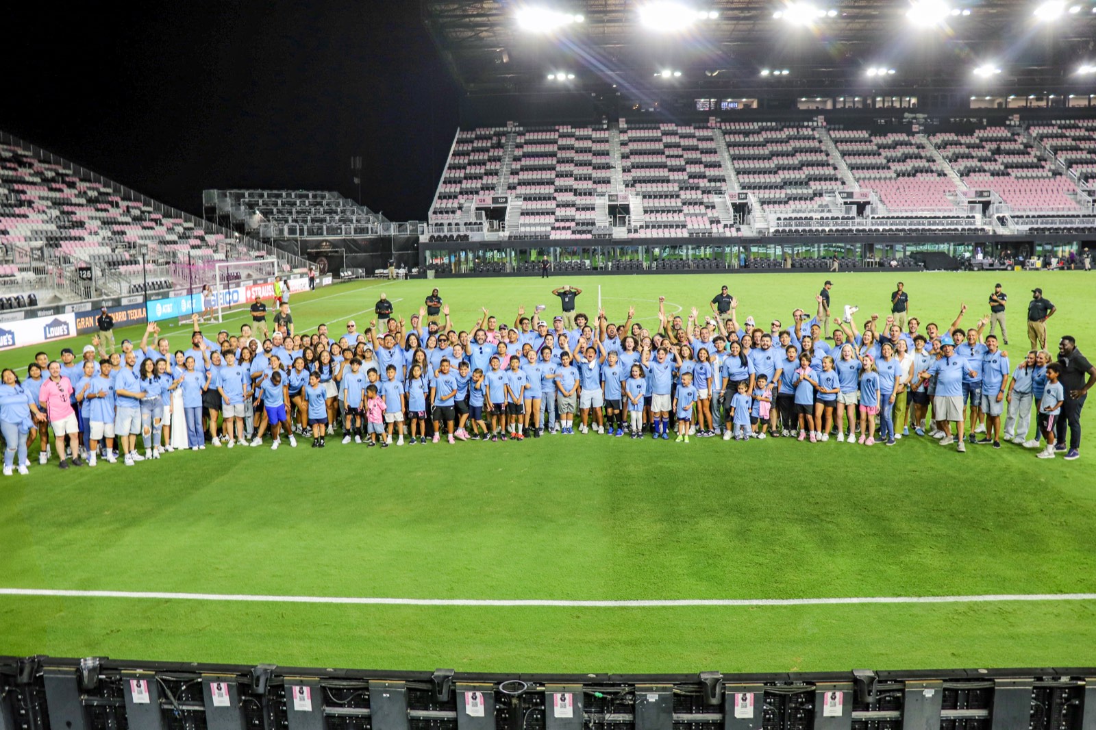 Oasis Futsal Academy players and families on the field at Inter Miami's stadium
